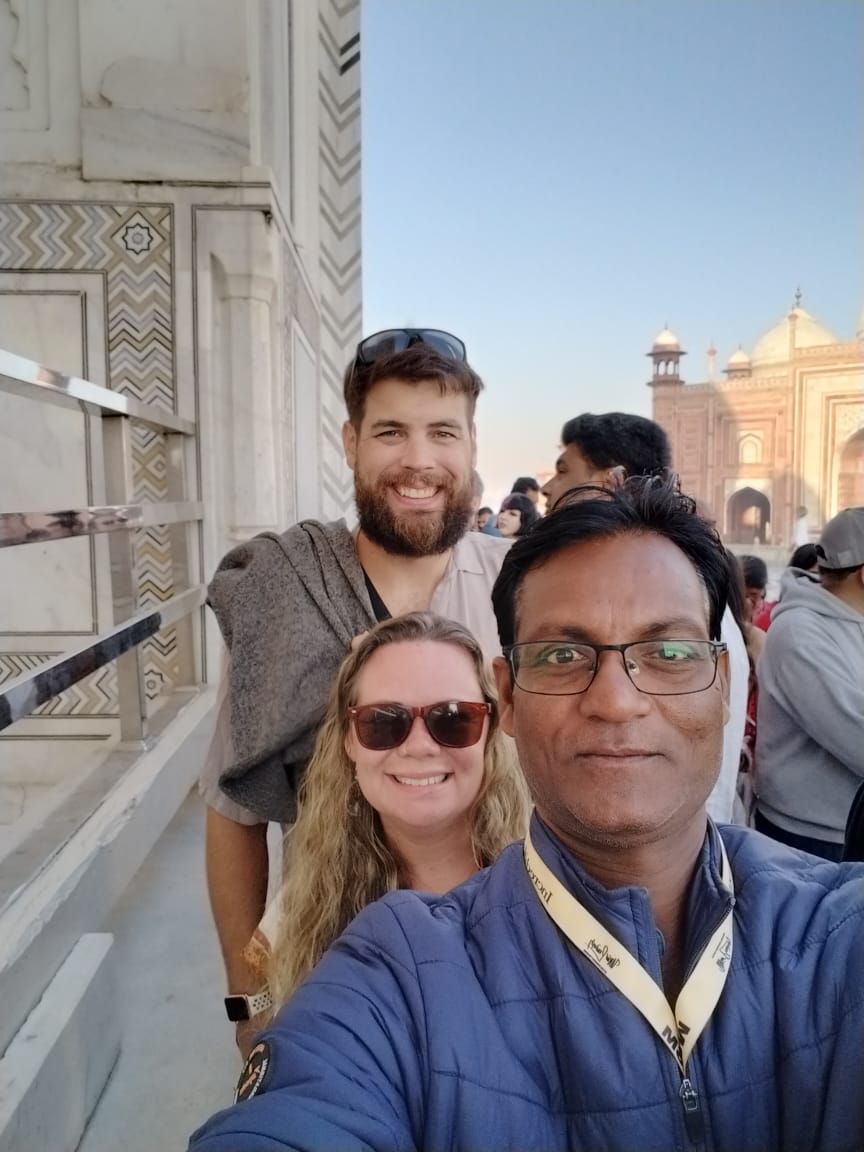 Mr. Verma with tourists smiling